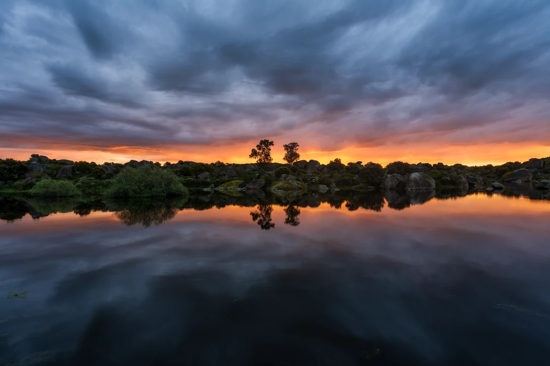 yellow and blue sunrise sky reflecting in a Spanish lake