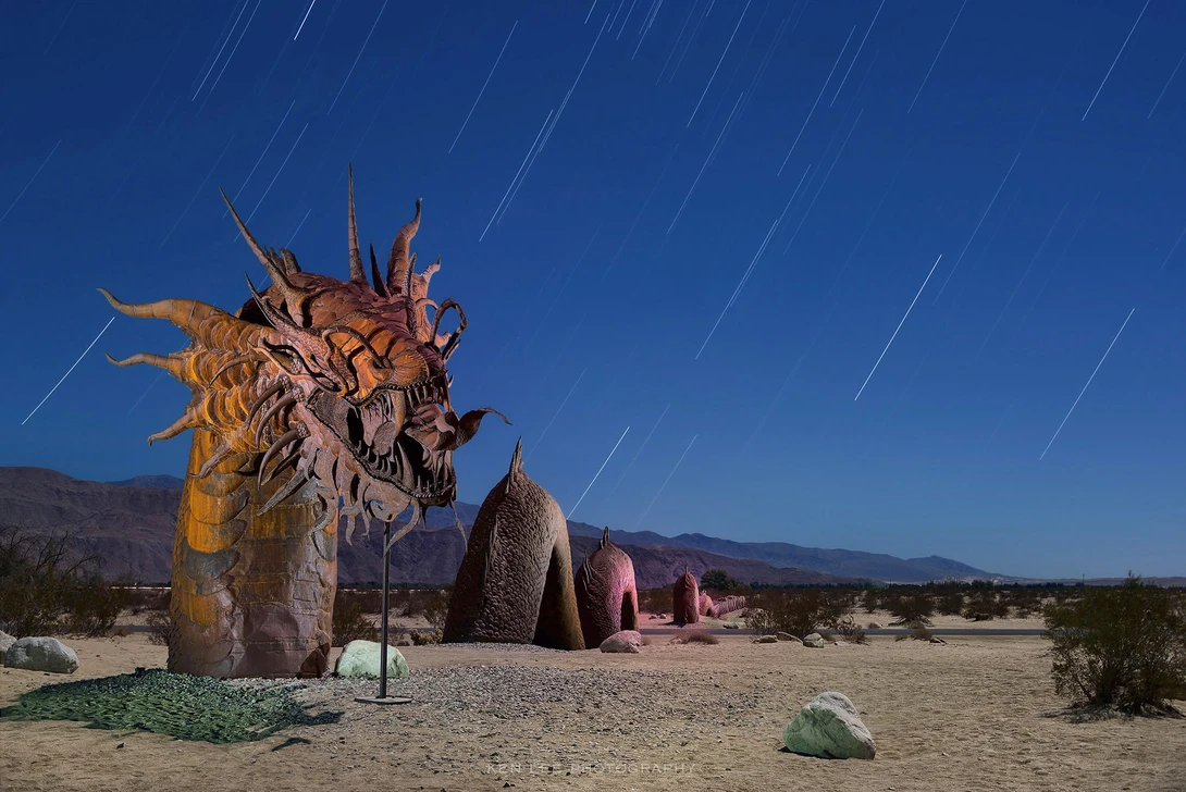 Night photo of Dragon Serpent, Borrego Springs, California, with star trails.
