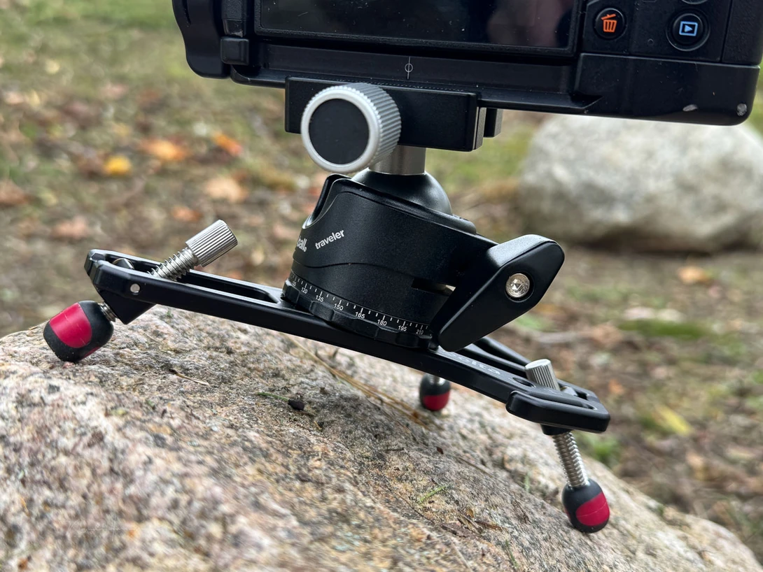 A ball head is mandatory. This is the Platypod Traveler. Small and designed for this kind of use.