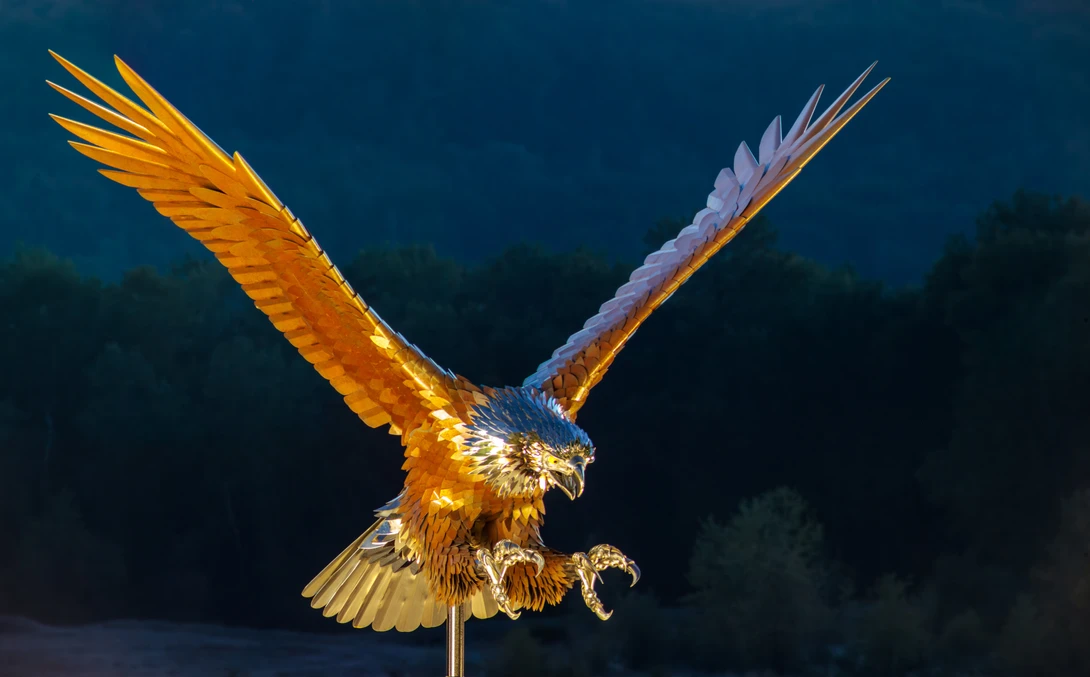 Golden eagle in flight with wings spread wide against dark blue background