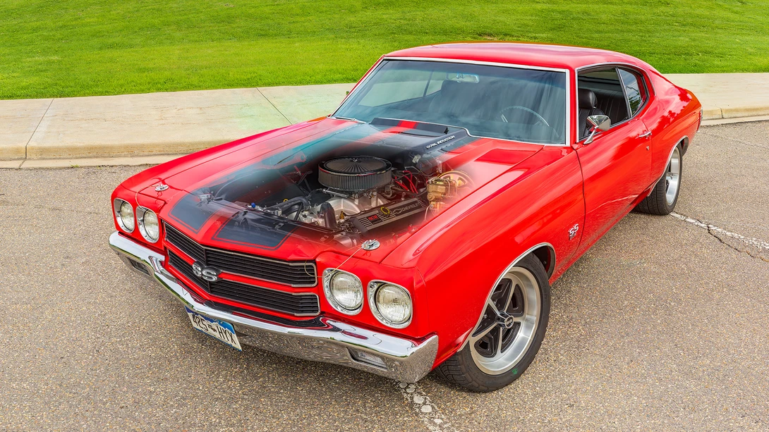 Red classic Chevrolet Chevelle SS muscle car with black hood stripes and a translucent engine overlay, parked on asphalt.