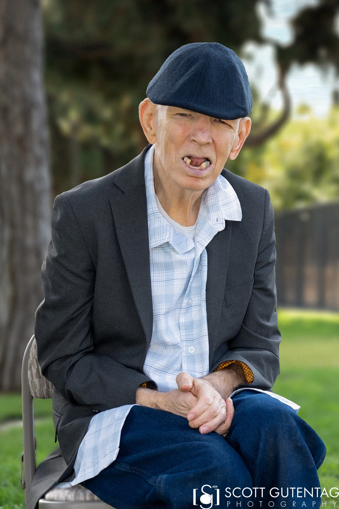 View Man in Cap Enjoying the Park by Scott Gutentag